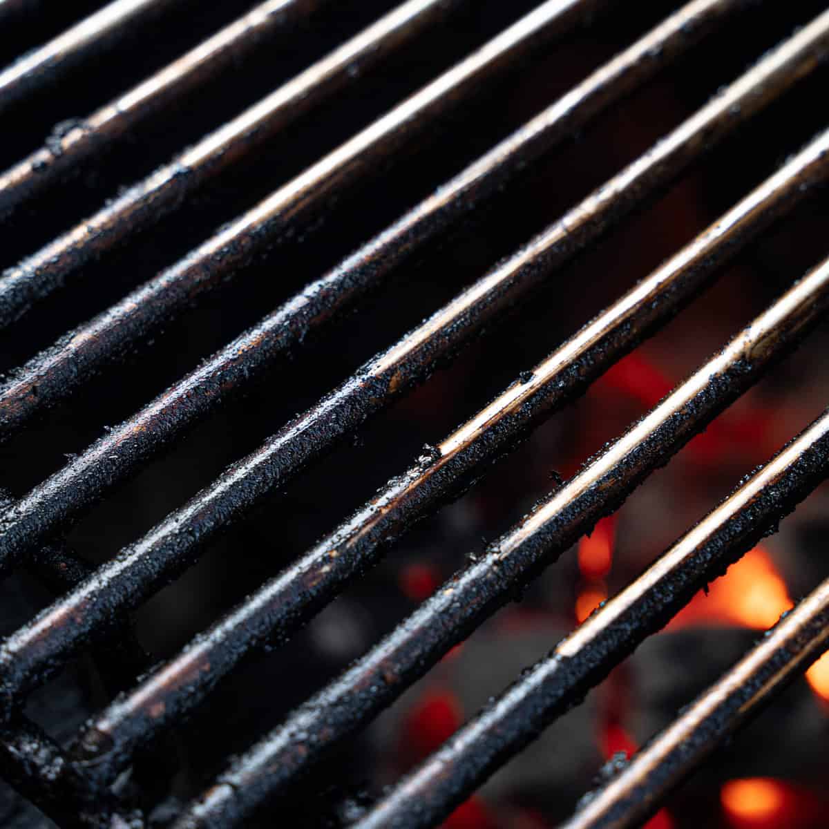 Showing grill grates that need to be cleaned to reduce the likelihood of chicken sticking to the grill
