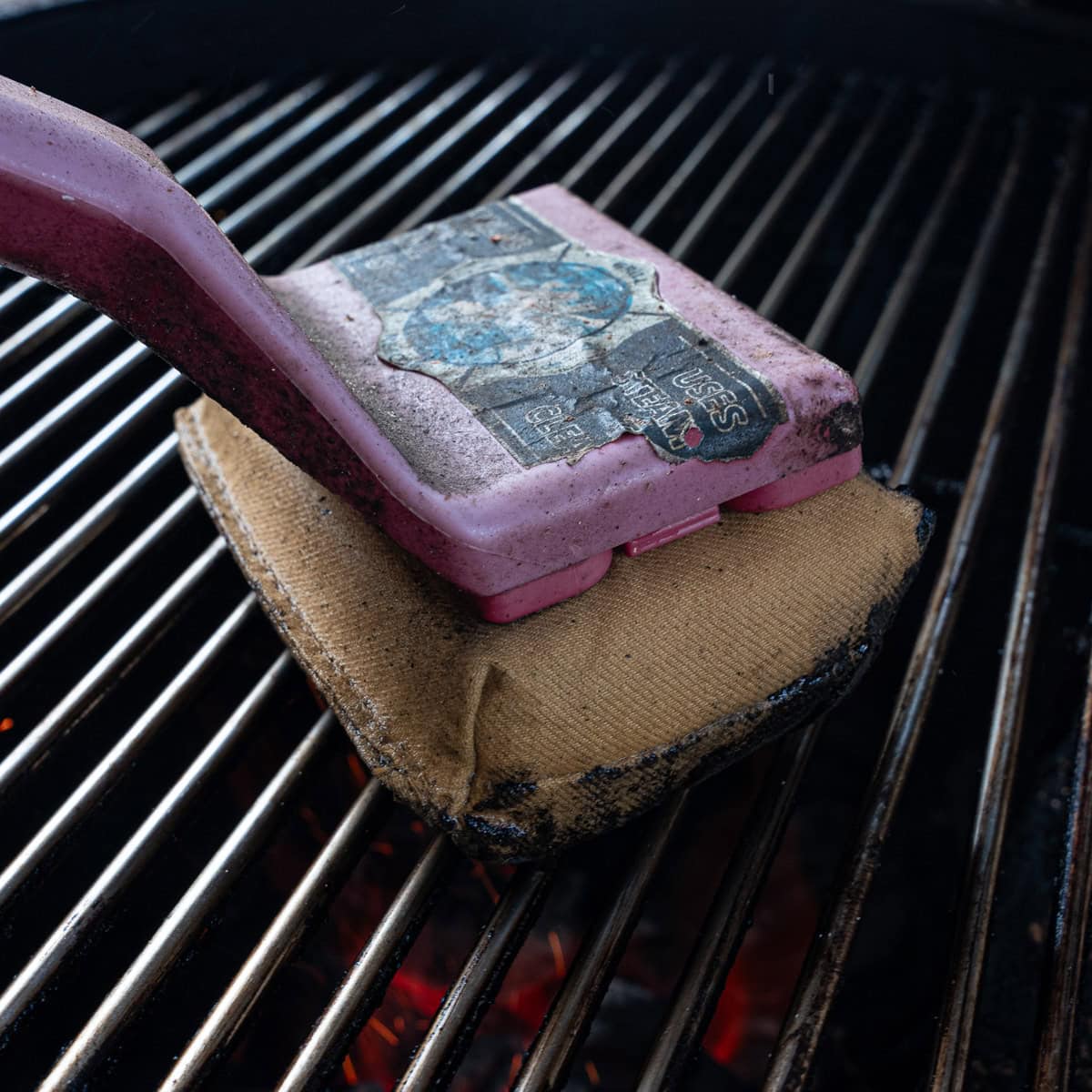 Using Grill Brush on grates to clean the grates