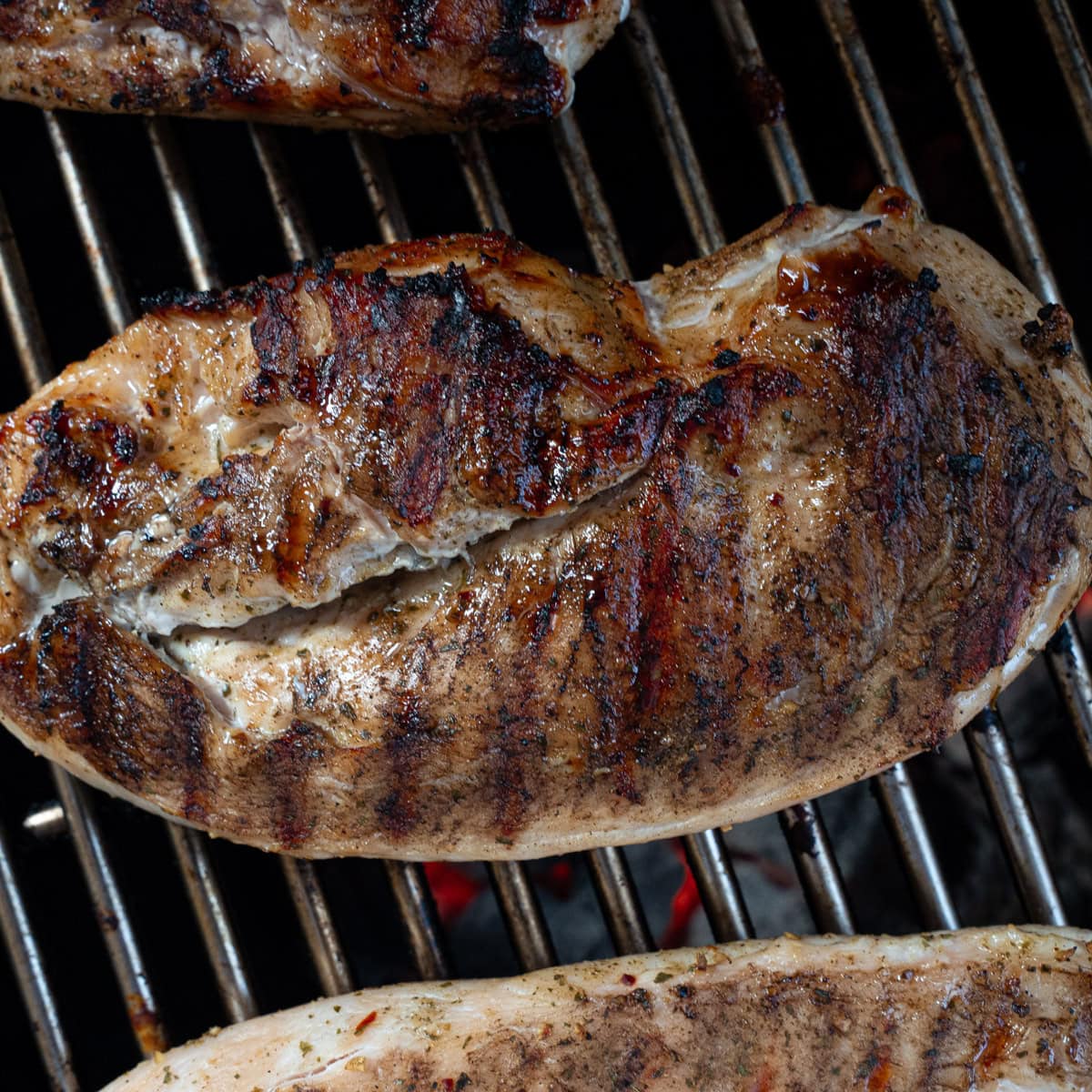 Showing how to cook chicken breast on the grill without it sticking to the grates