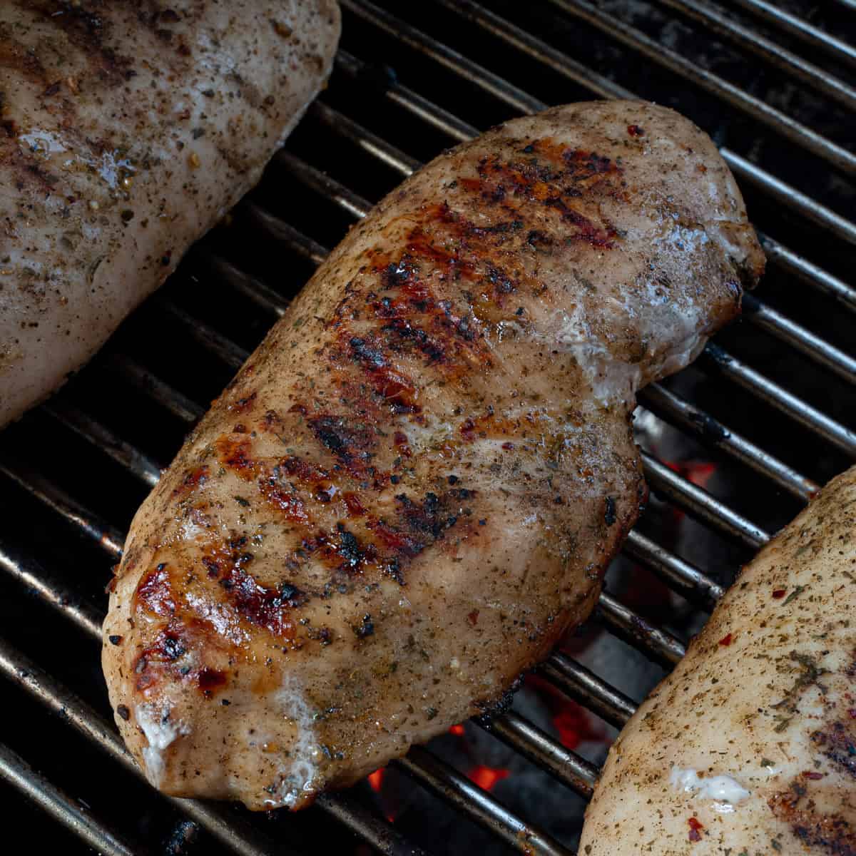 Showing how to cook chicken breast on the grill without it sticking
