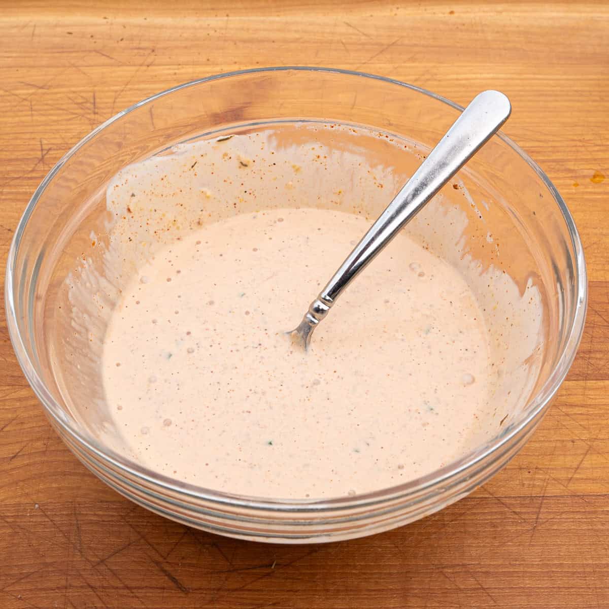 Homemade cajun remoulade being used for the empanada sauce recipe
