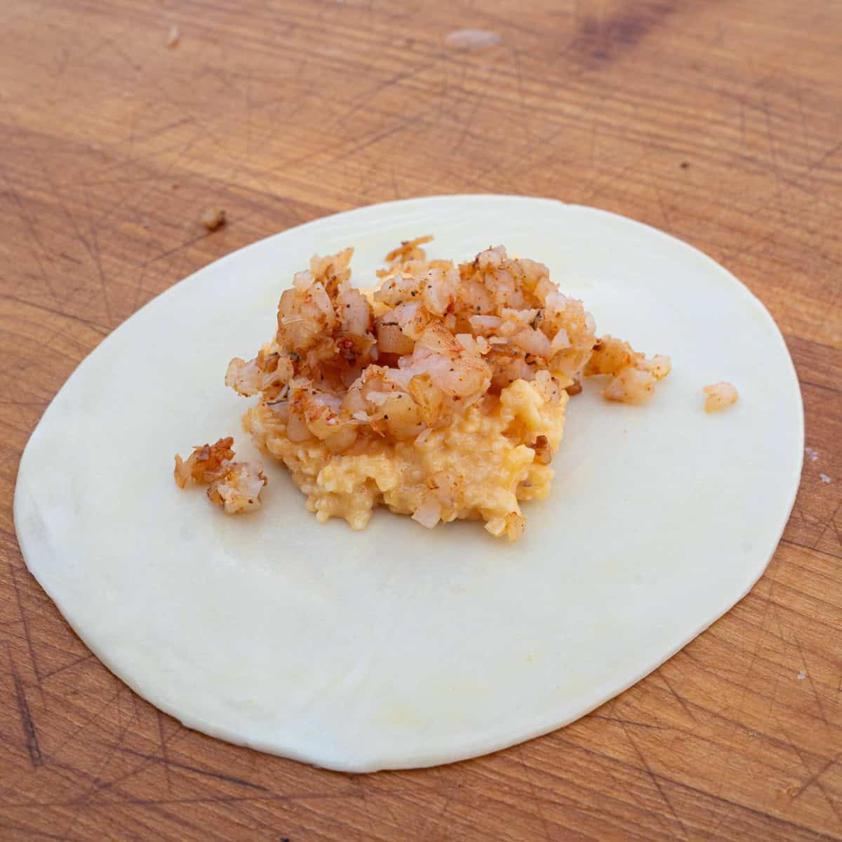 Empanada Wrapper with Spoonful of Shrimp & Grits