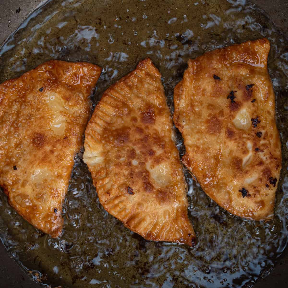 Golden Brown Empanadas Shallow Frying in Oil