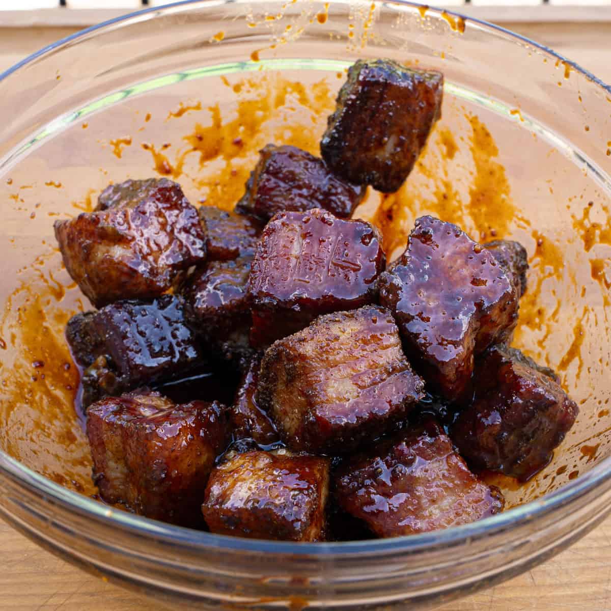 Pork Belly Being Mixed with the Bourbon Molasses Glaze