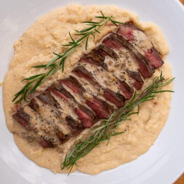 Prepared Three Cheese Grits served with grilled flank steak