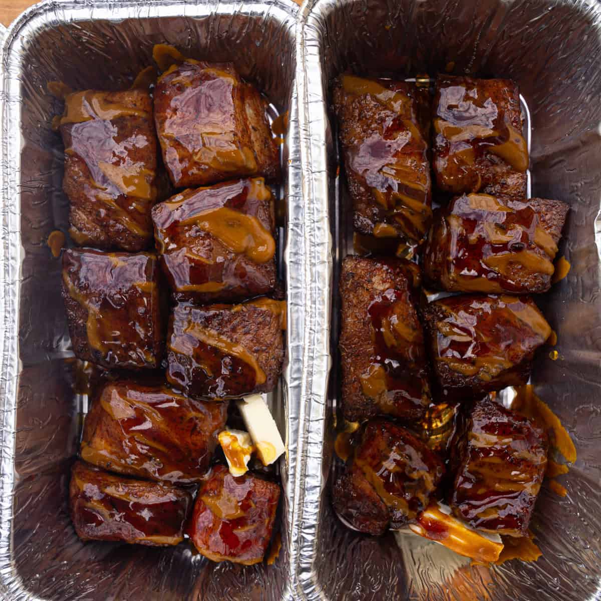 Smoked pork belly being sauced up with the hot honey glaze and being wrapped to go back onto the smoker