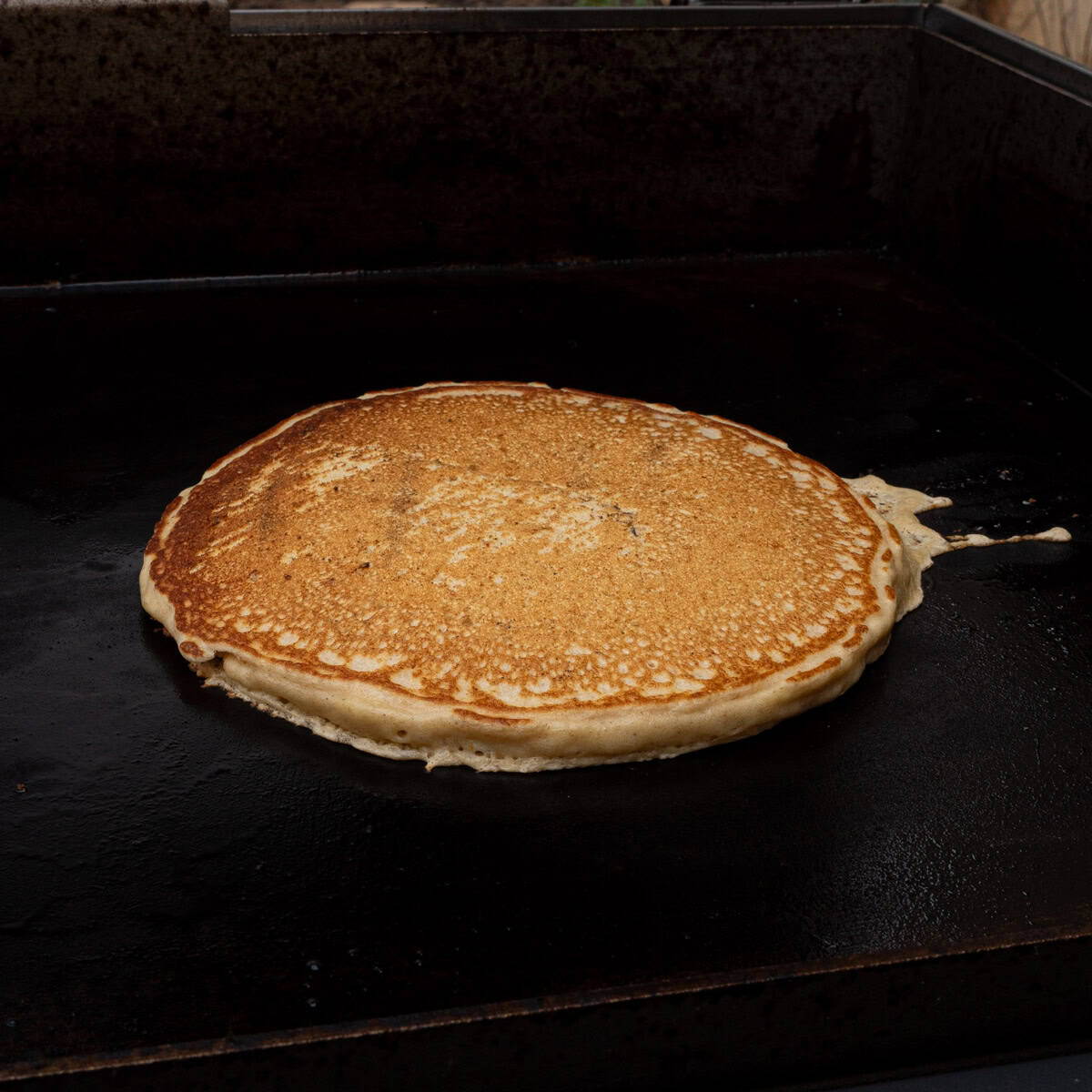Recently flipped pancake on the griddle