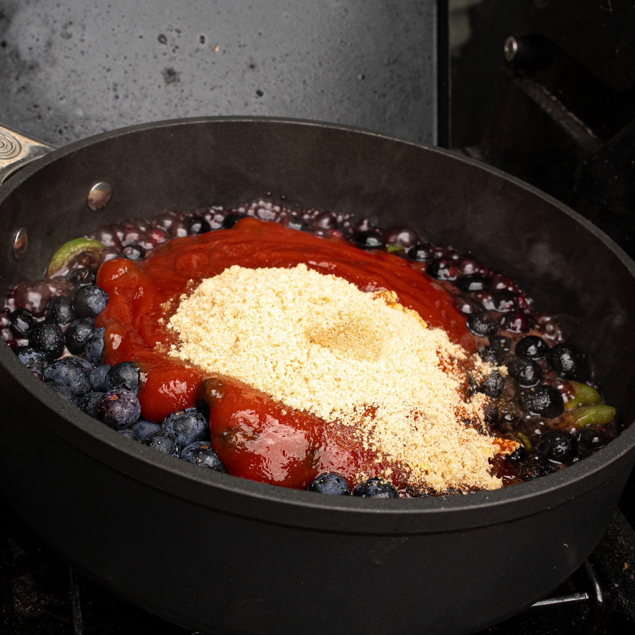Adding the ingredients for the bbq sauce to the skillet