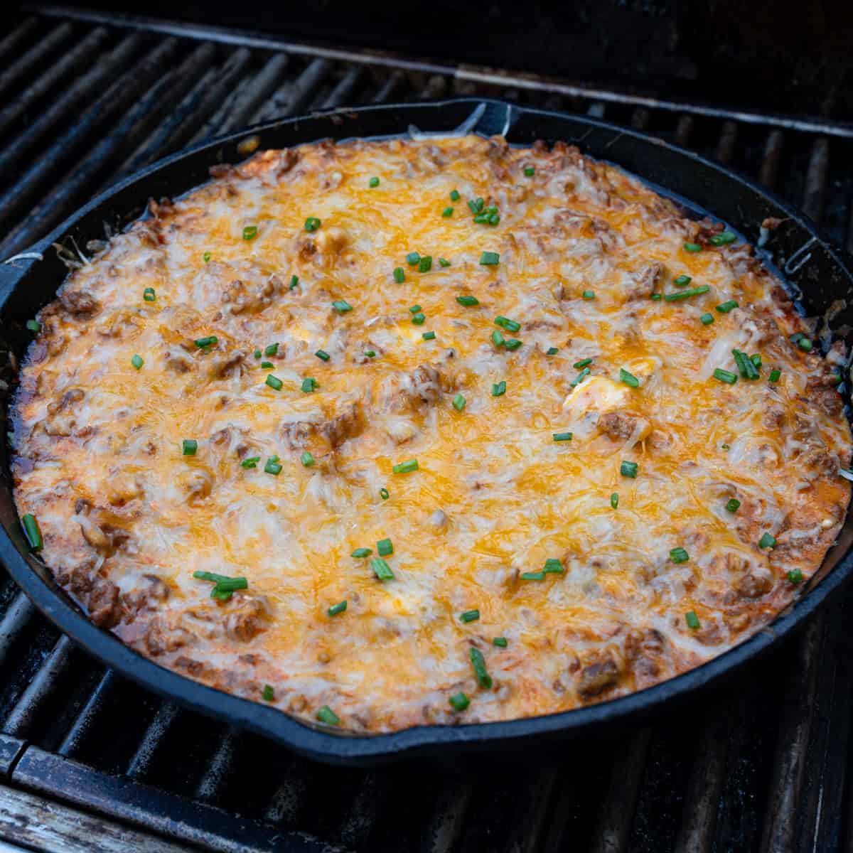 Final layer of cheese melting on top of grilled chili cheese dip