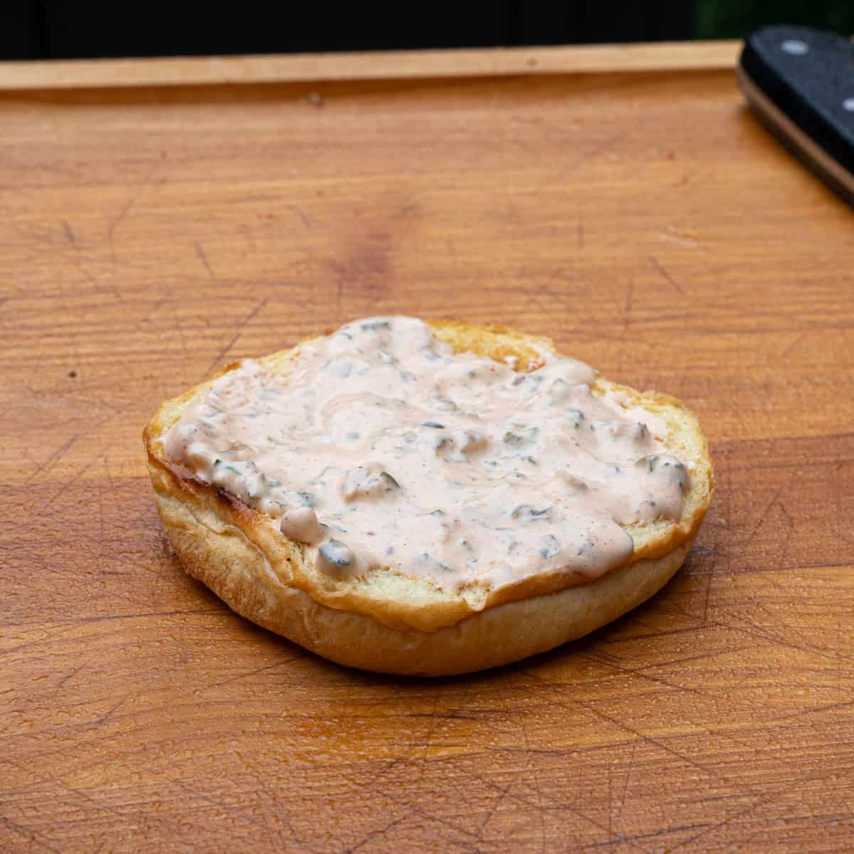 Adding Creole Tartar Sauce to Sandwich Bun