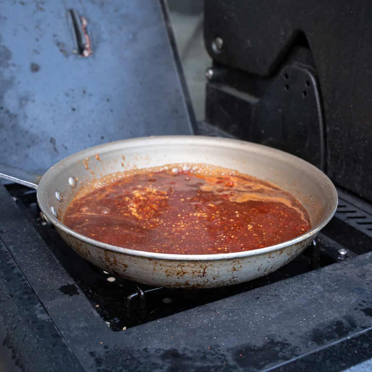 Simmering Hot Honey BBQ Sauce in a pan to reduce