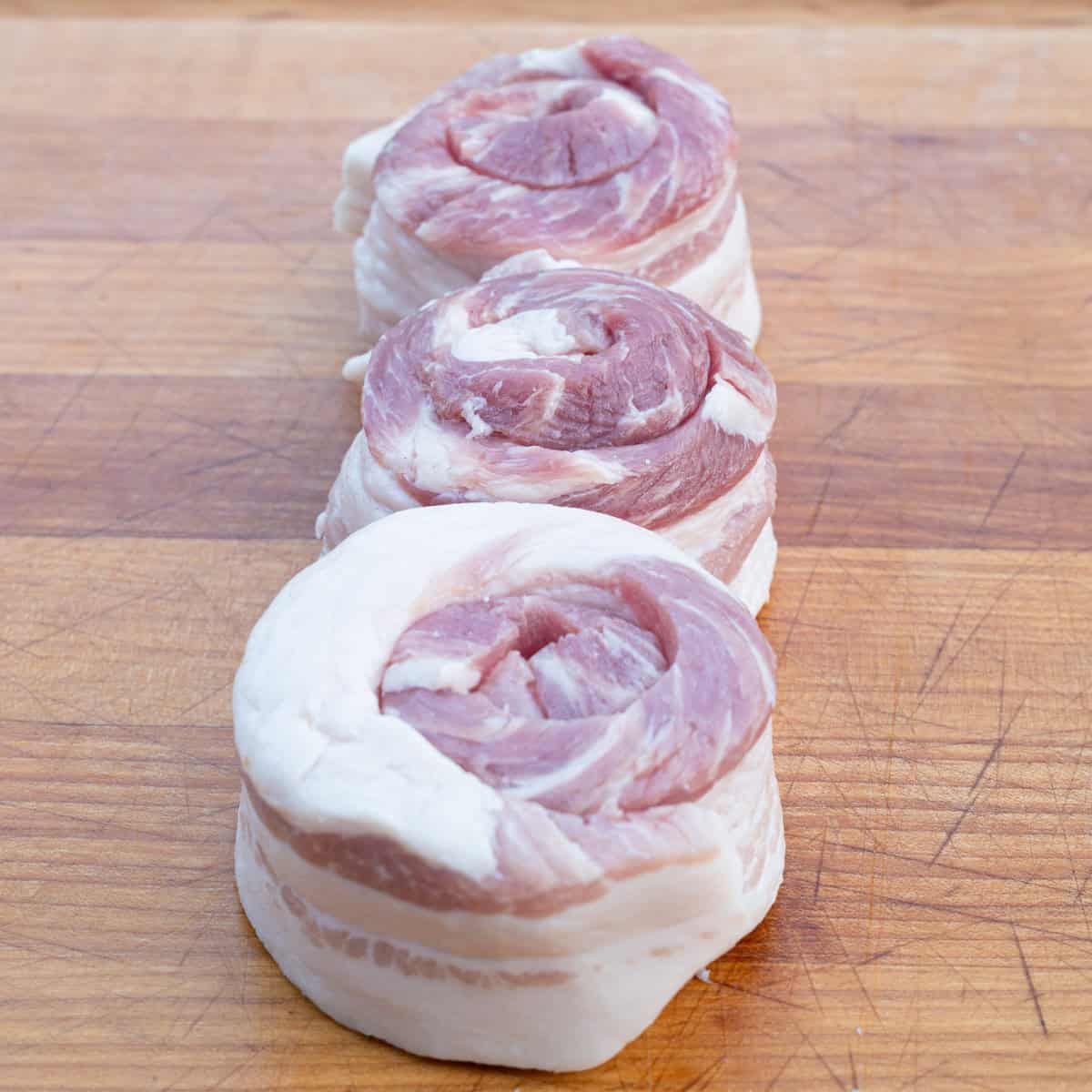 Fresh pork belly, sliced & rolled -- ready to be skewered