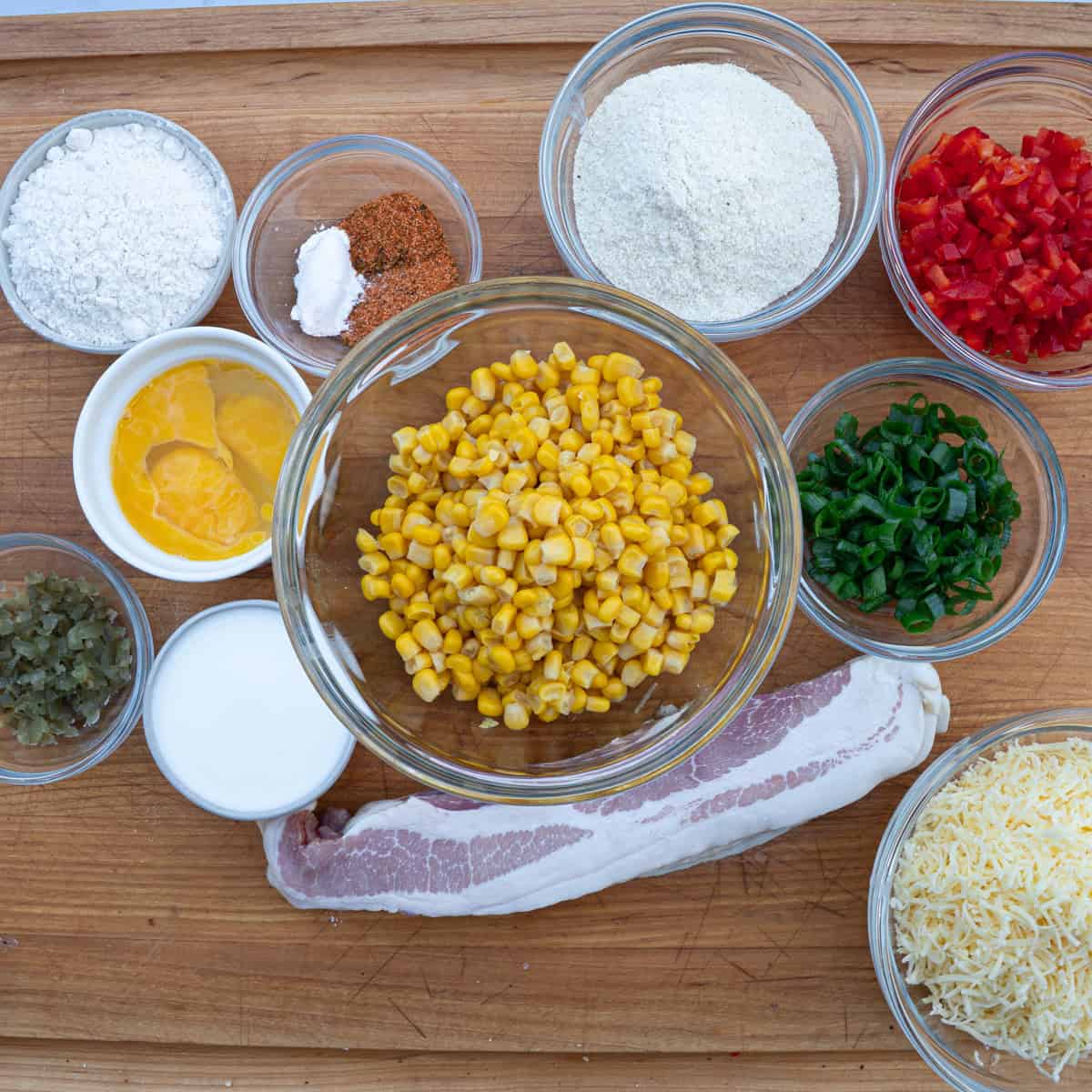 Fresh corn, chopped tomatoes, scallions, cheese, and spices for BBQ dishes.