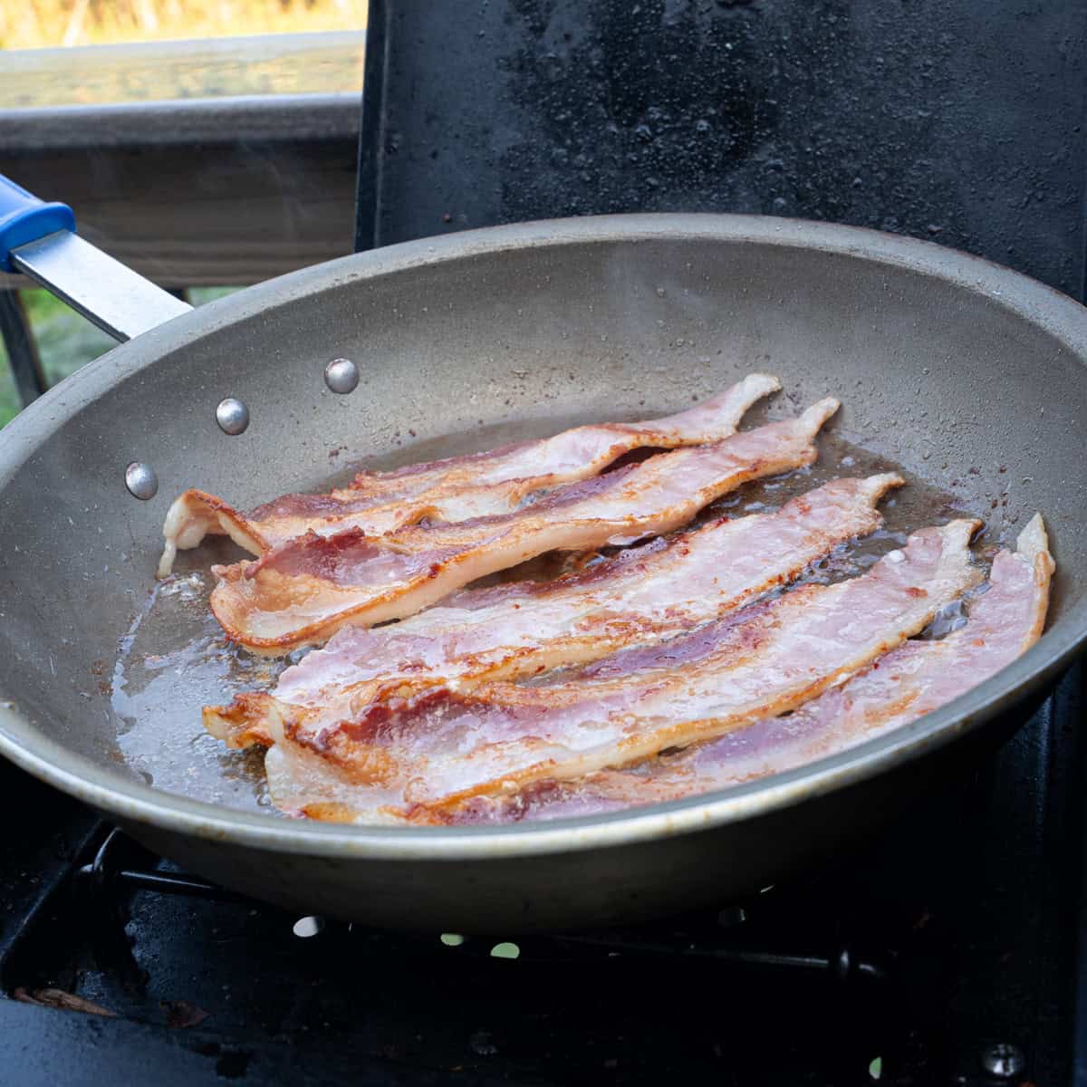 frying bacon in a skillet