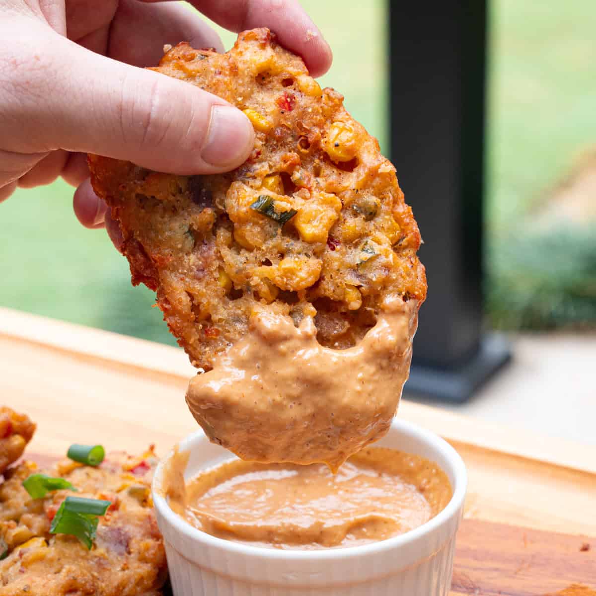 Dipping Corn and Bacon Fritters in Cajun Remoulade