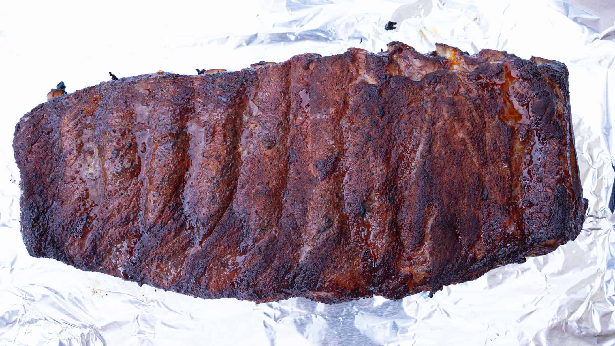 ribs taken off the smoker after two hours, ready to be wrapped