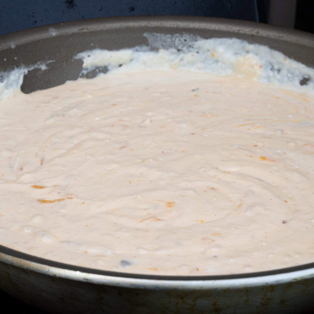 Melting the cheese into the cream sauce