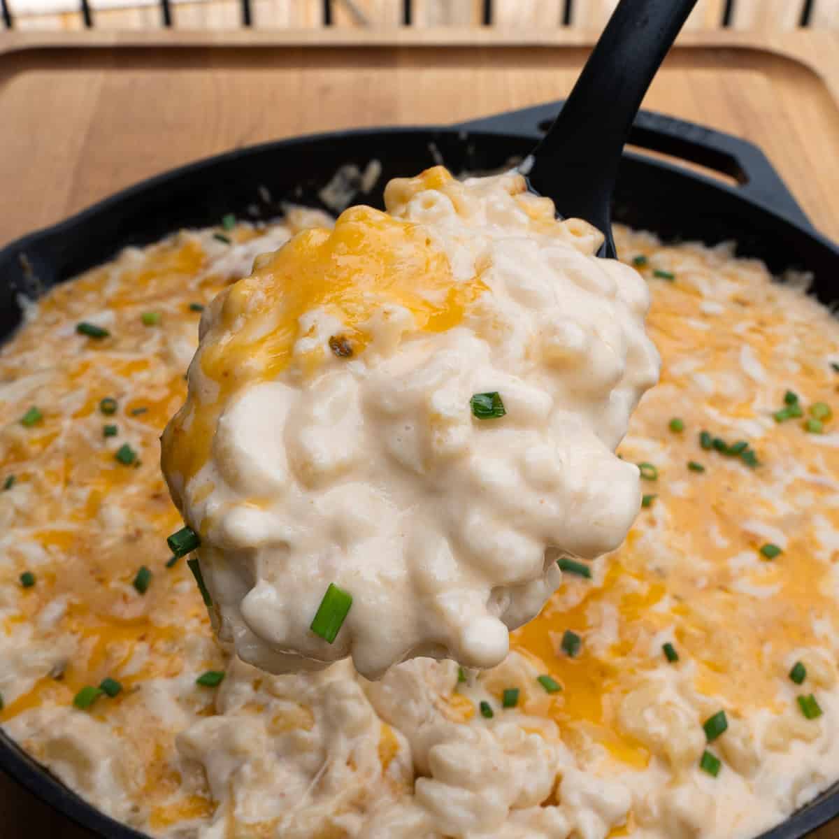 Serving a spoonful of the creamy southern Mac and cheese with gouda cheese