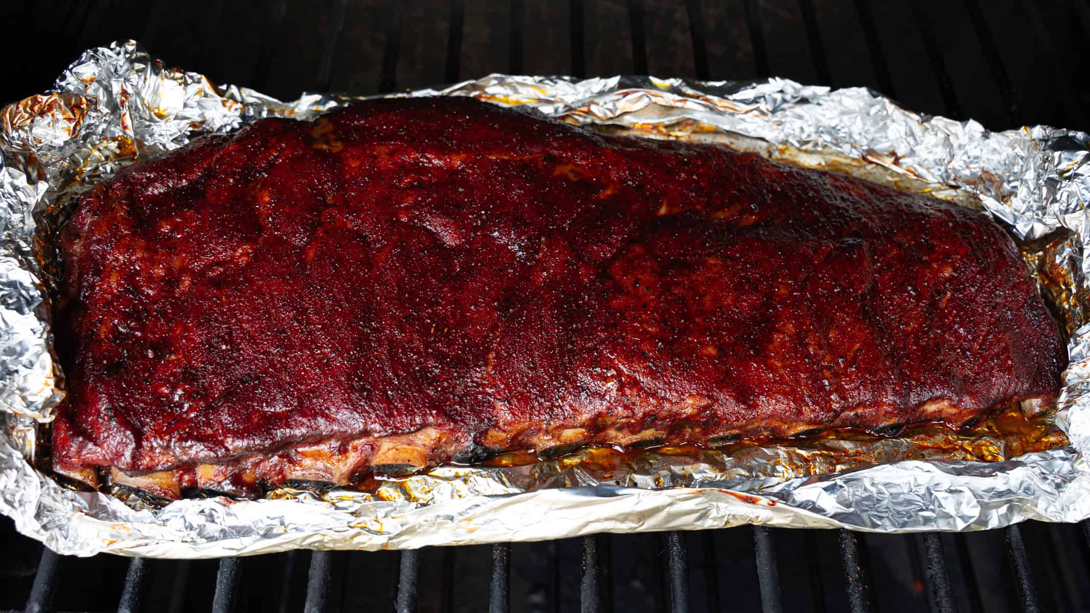 Letting the glaze tack on to the ribs during the final hour of the cooking process