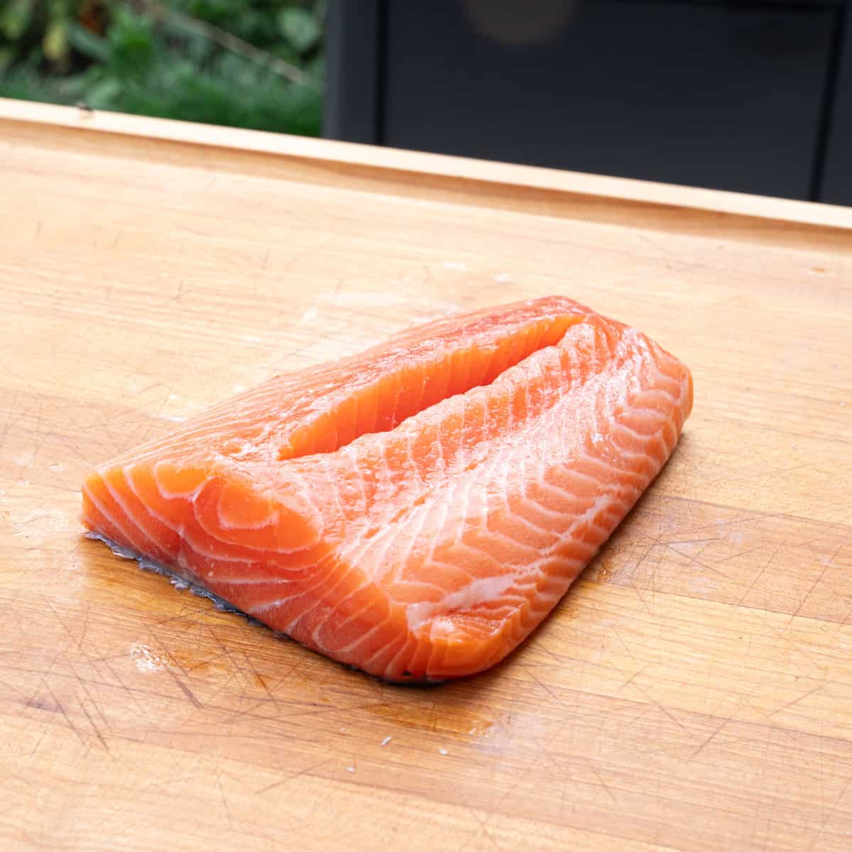 Showing how salmon is cut from the top side so it can be stuffed