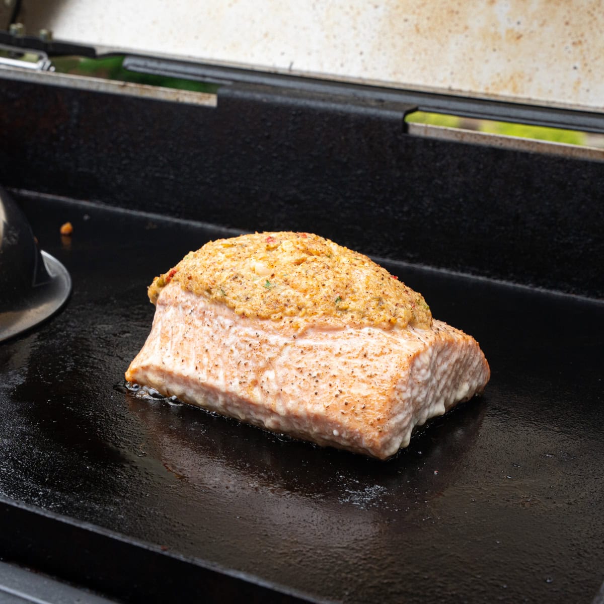 This stuffed salmon has been cooking under a dome that was just removed, and it is now opaque.