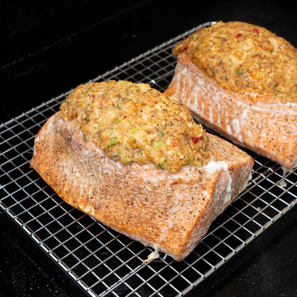 Finishing cooking salmon stuffed with shrimp stuffing on wire racks