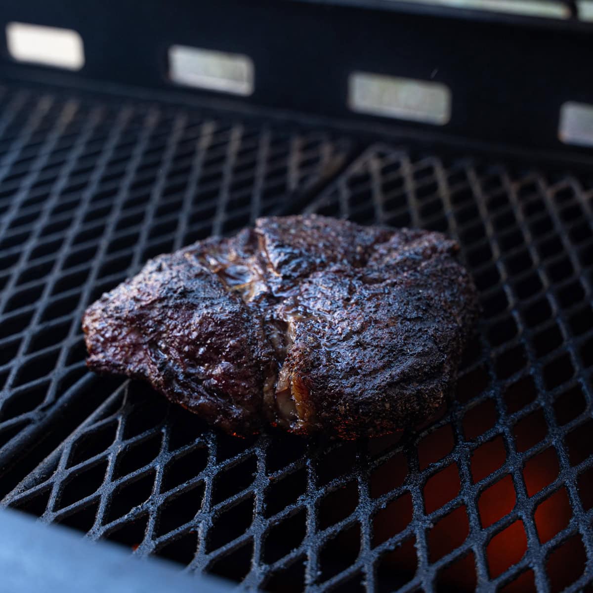 Chuck Roast on the smoker with the bark starting to form