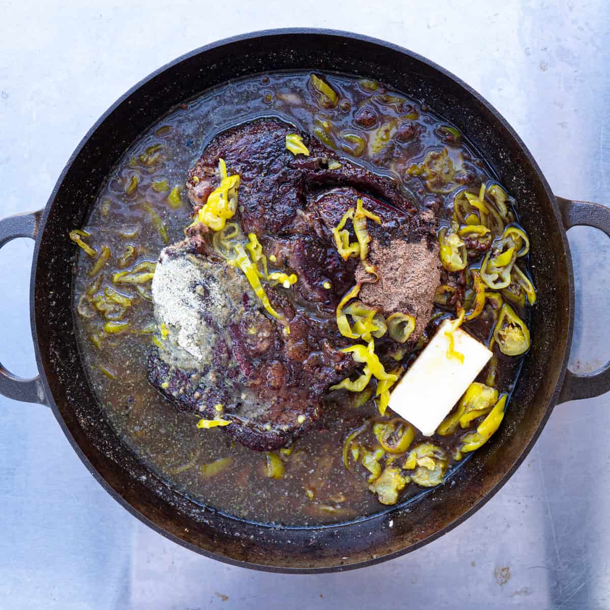 Placing Chuck Roast and Remaining Ingredients in a Lage Skillet to Braise