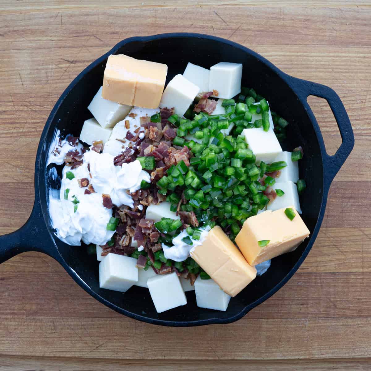 Gathering all of the ingredients in a skillet for the smoked Jalapeño Popper Dip