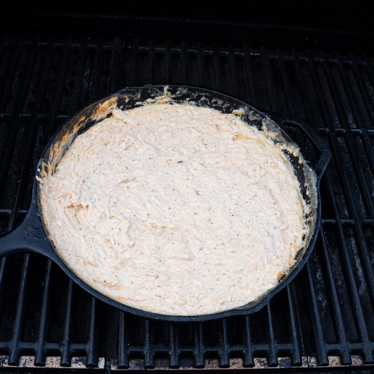 cajun crab dip in the final cooking stages on the smoker
