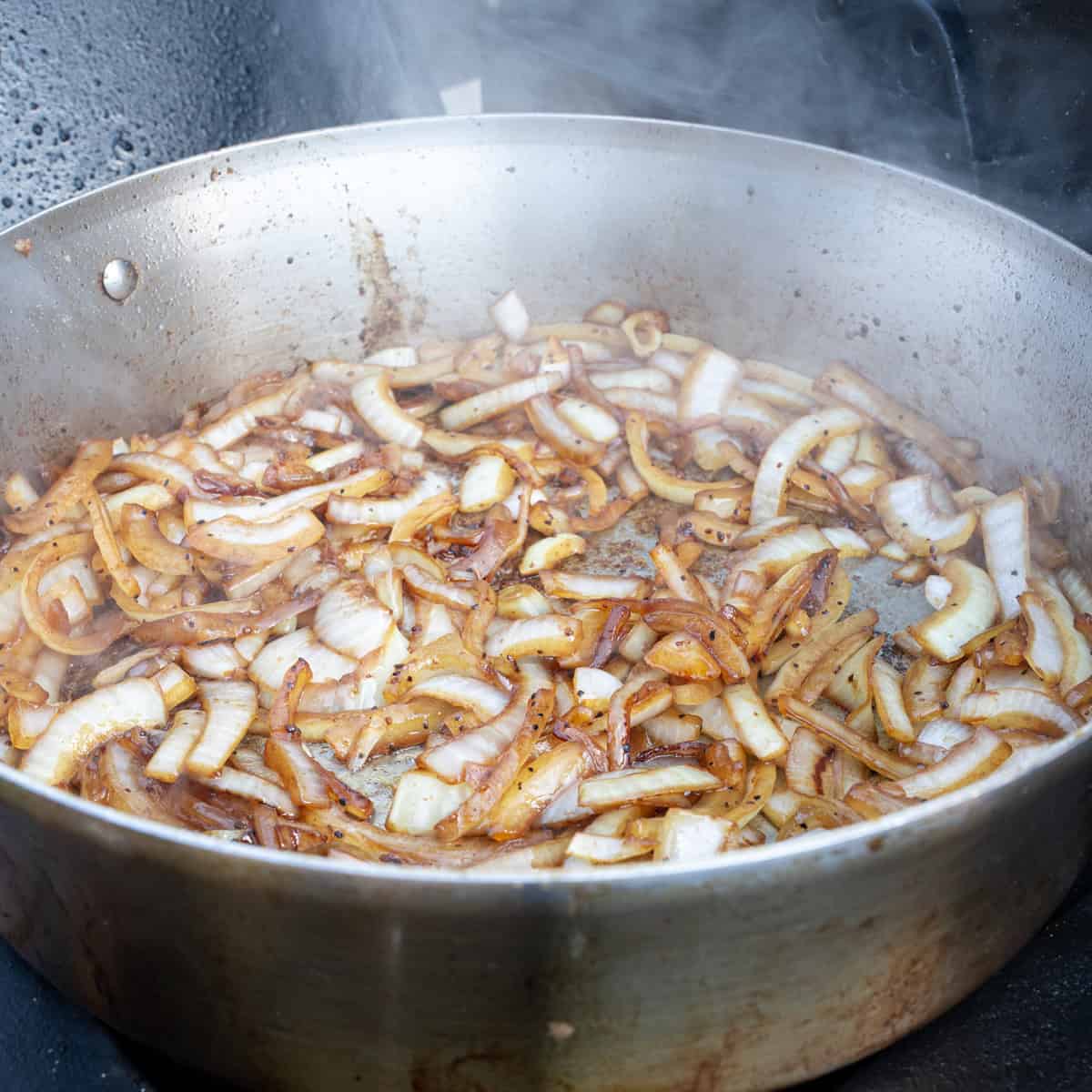 Lightly browning salted onions in a skillet