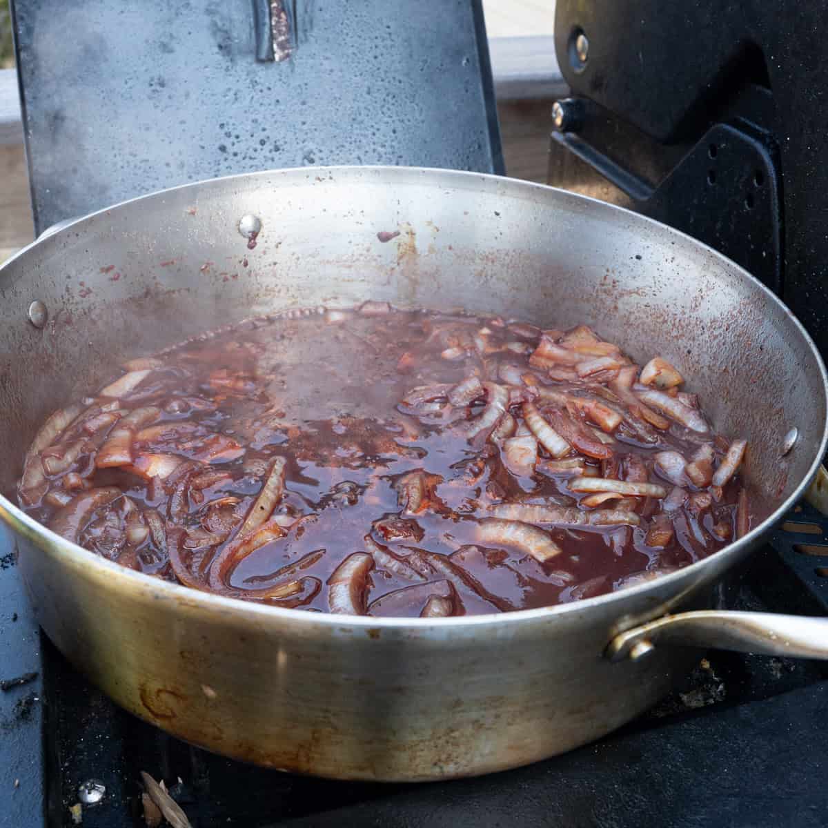 Reducing wine in the pan with sautéed onions
