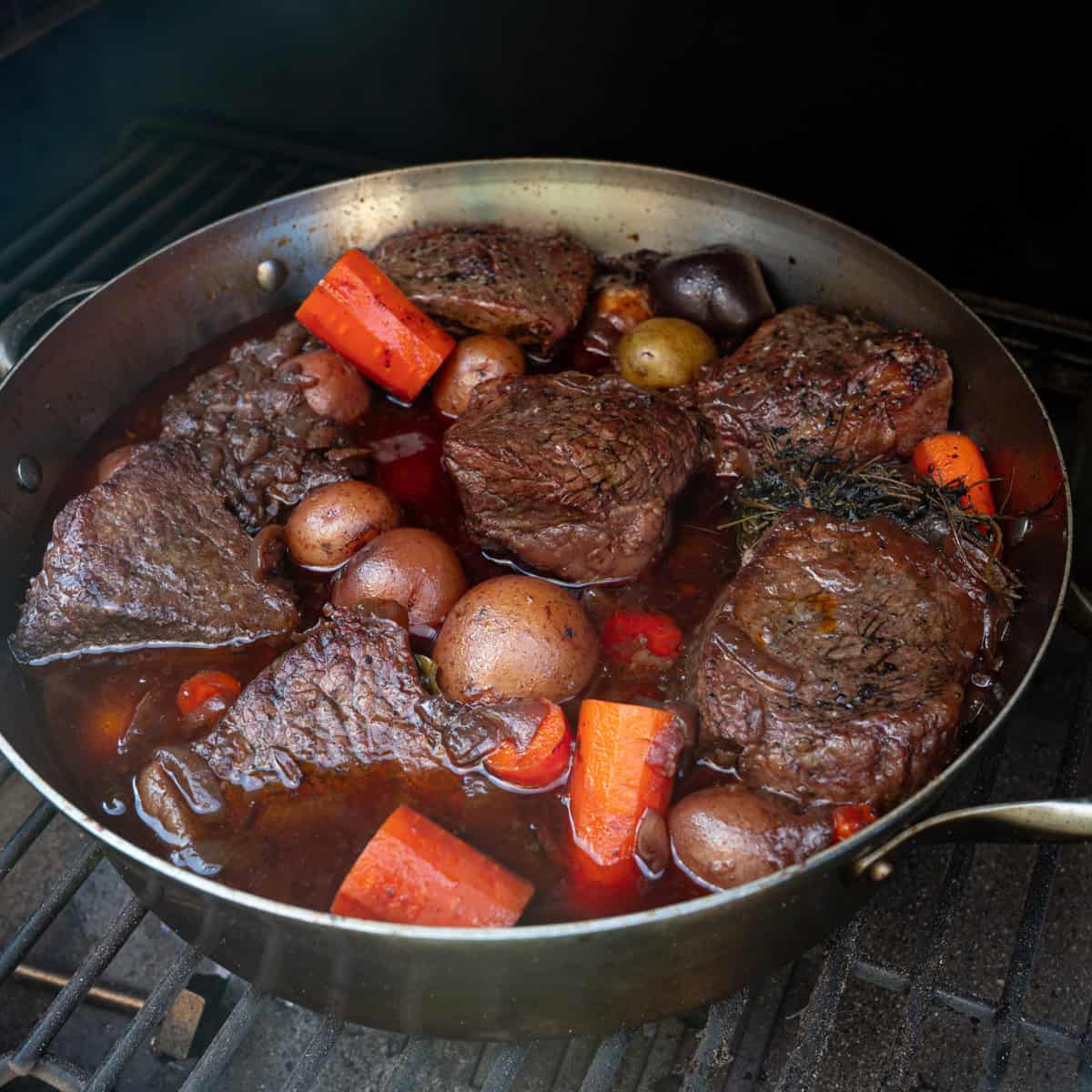 Bottom round roast braising in a large skillet