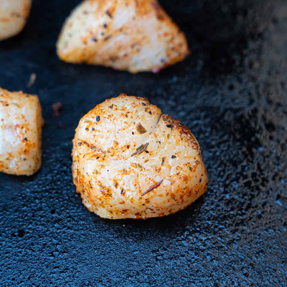Creole Seasoned Scallops freshly placed on a hot griddle