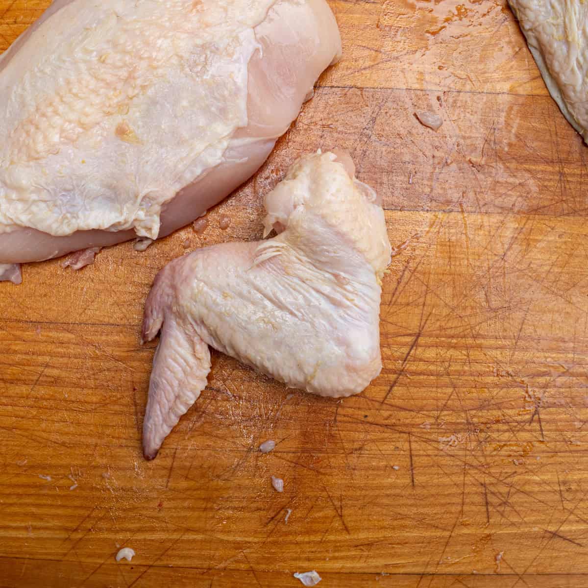A raw chicken wing sliced from a whole chicken