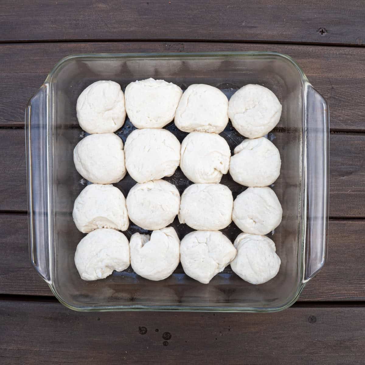 Pillsbury biscuits cut in half, rolled into dough balls, and placed in a square baking pan to be baked into the biscuit sliders