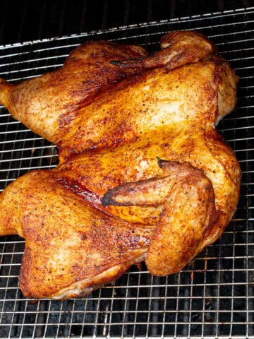 Spatchcock chicken smoking on a pellet grill