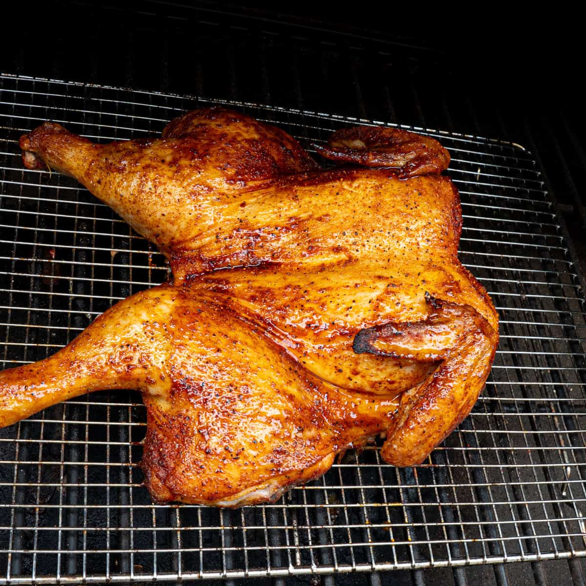 Spatchcock chicken smoking on a pellet grill