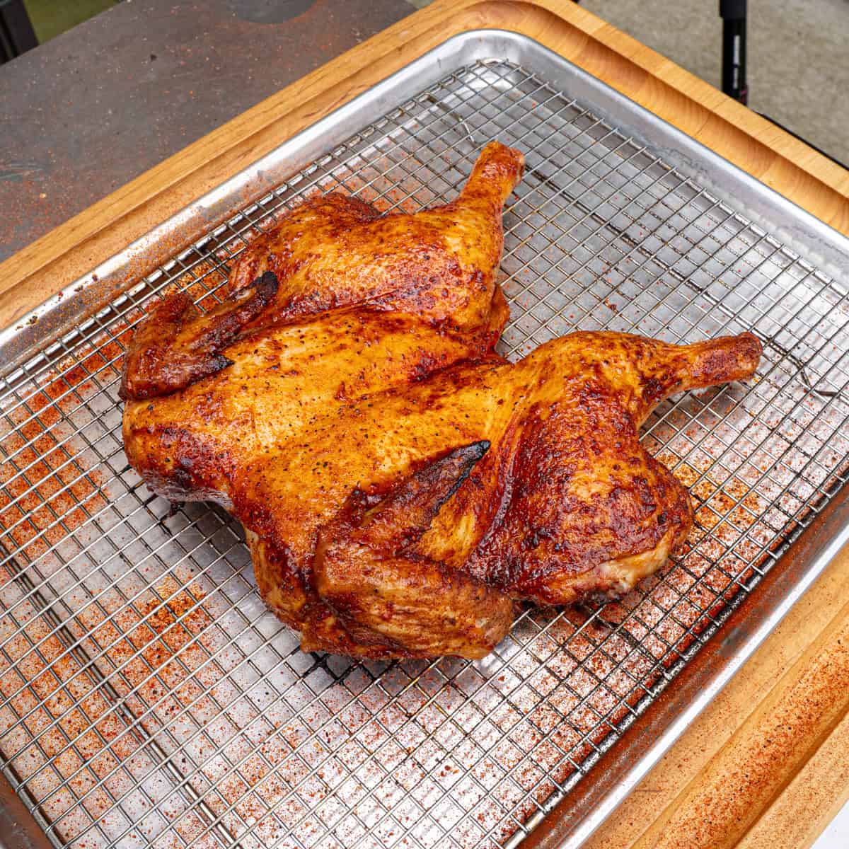 Smoked spatchcock chicken finished cooking and recently pulled off of a pellet grill