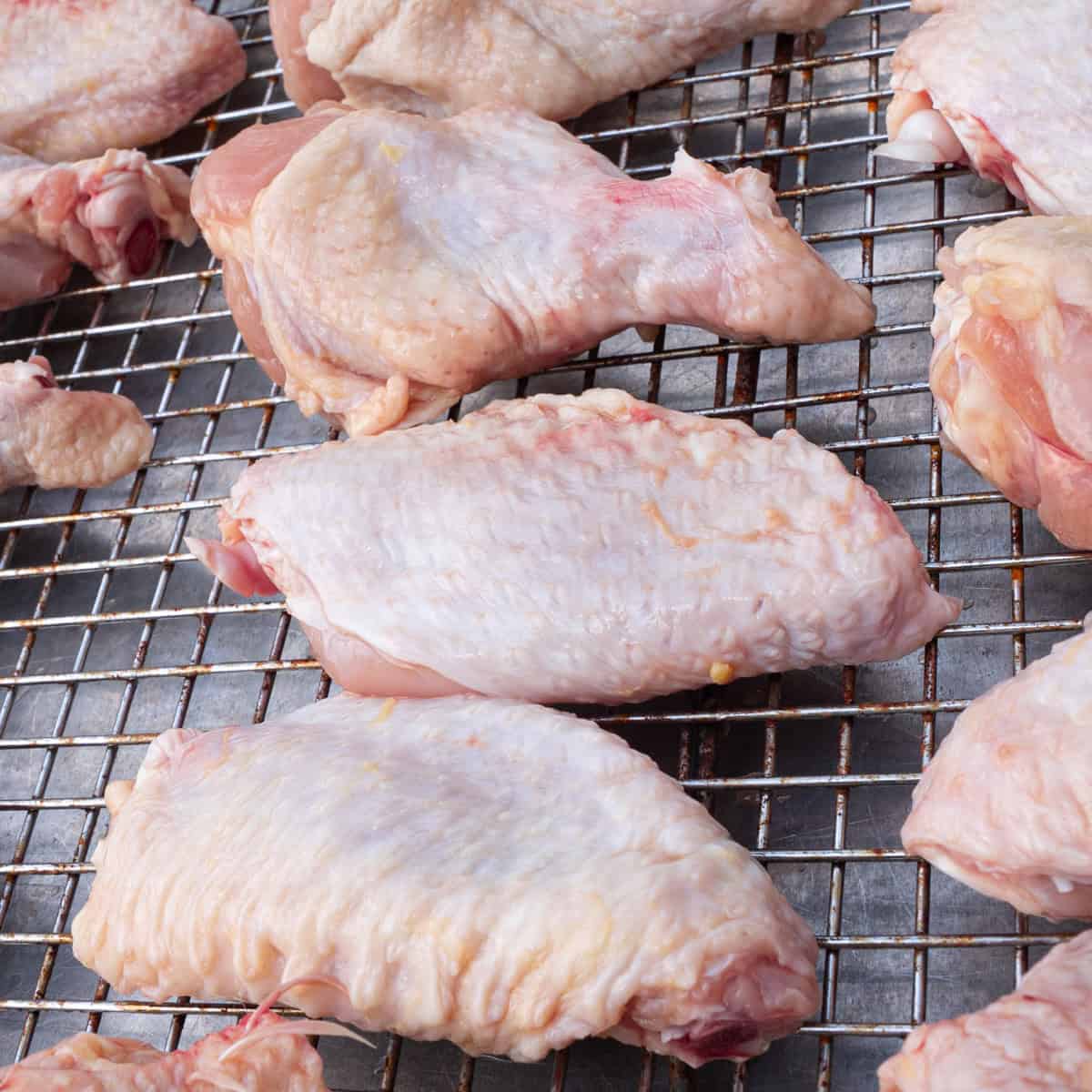 Chicken wings just pulled out of a brine, patted dry with a paper towel, and ready to be seasoned