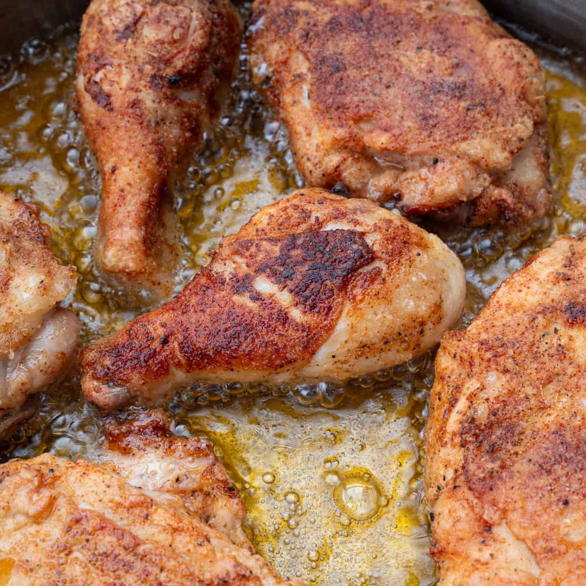 Golden brown chicken pan searing in oil