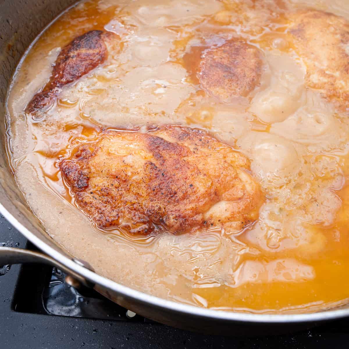 Chicken braising in gravy mixture