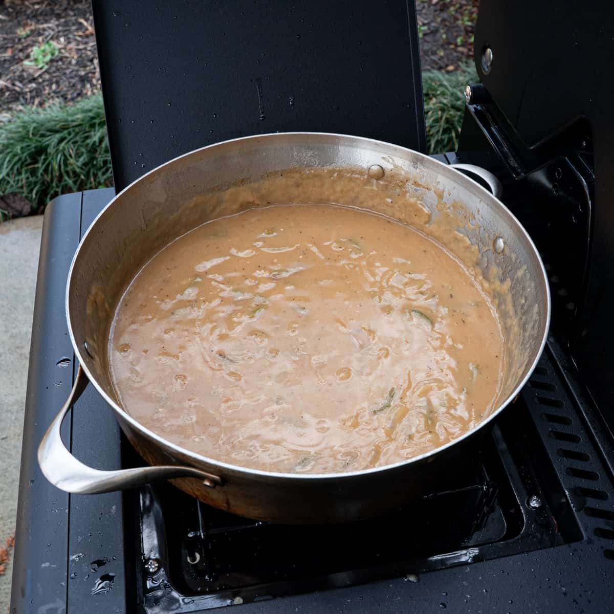Chicken gravy in a large pot made for smothered chicken
