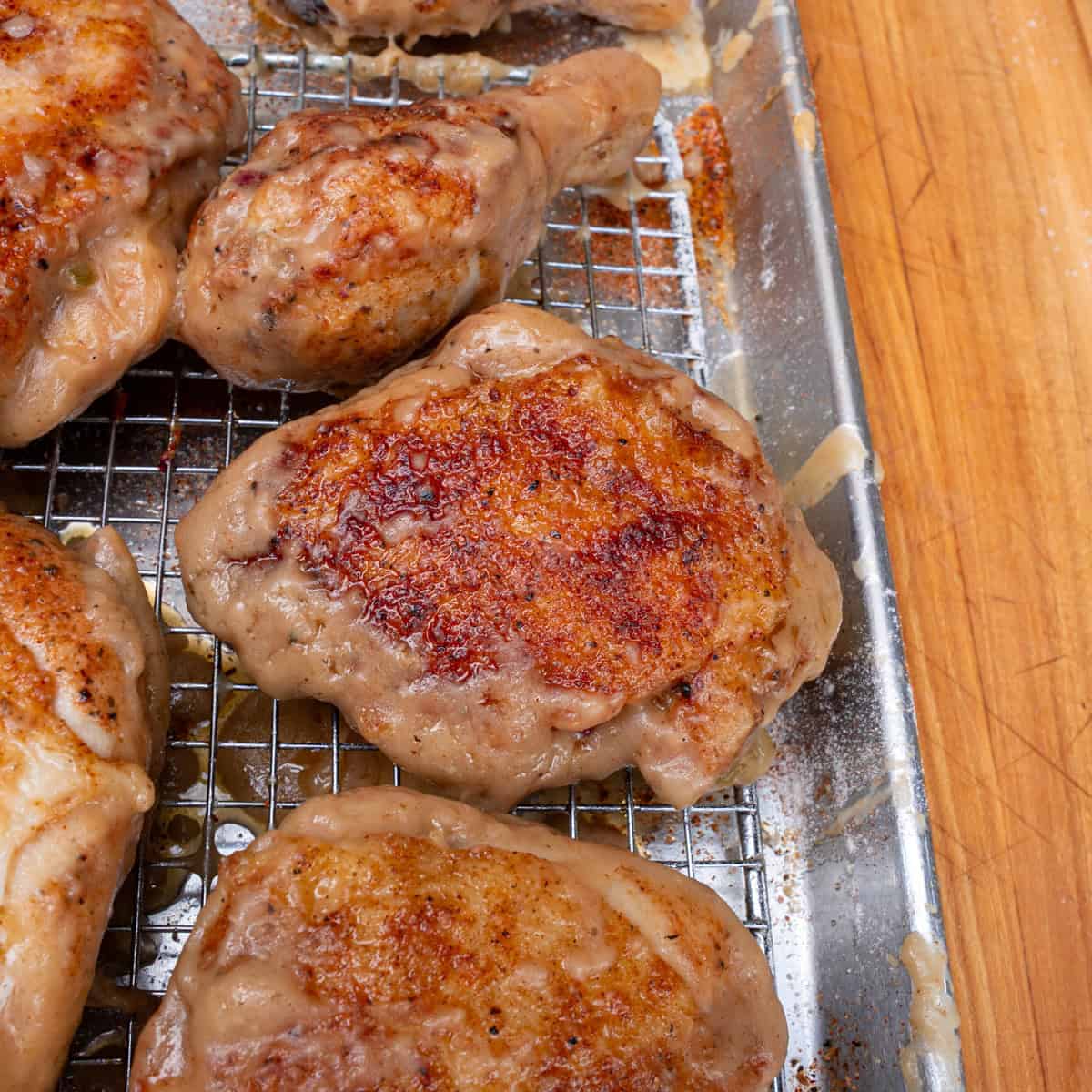 Pan seared chicken that was cooking in gravy freshly taken out of the pan