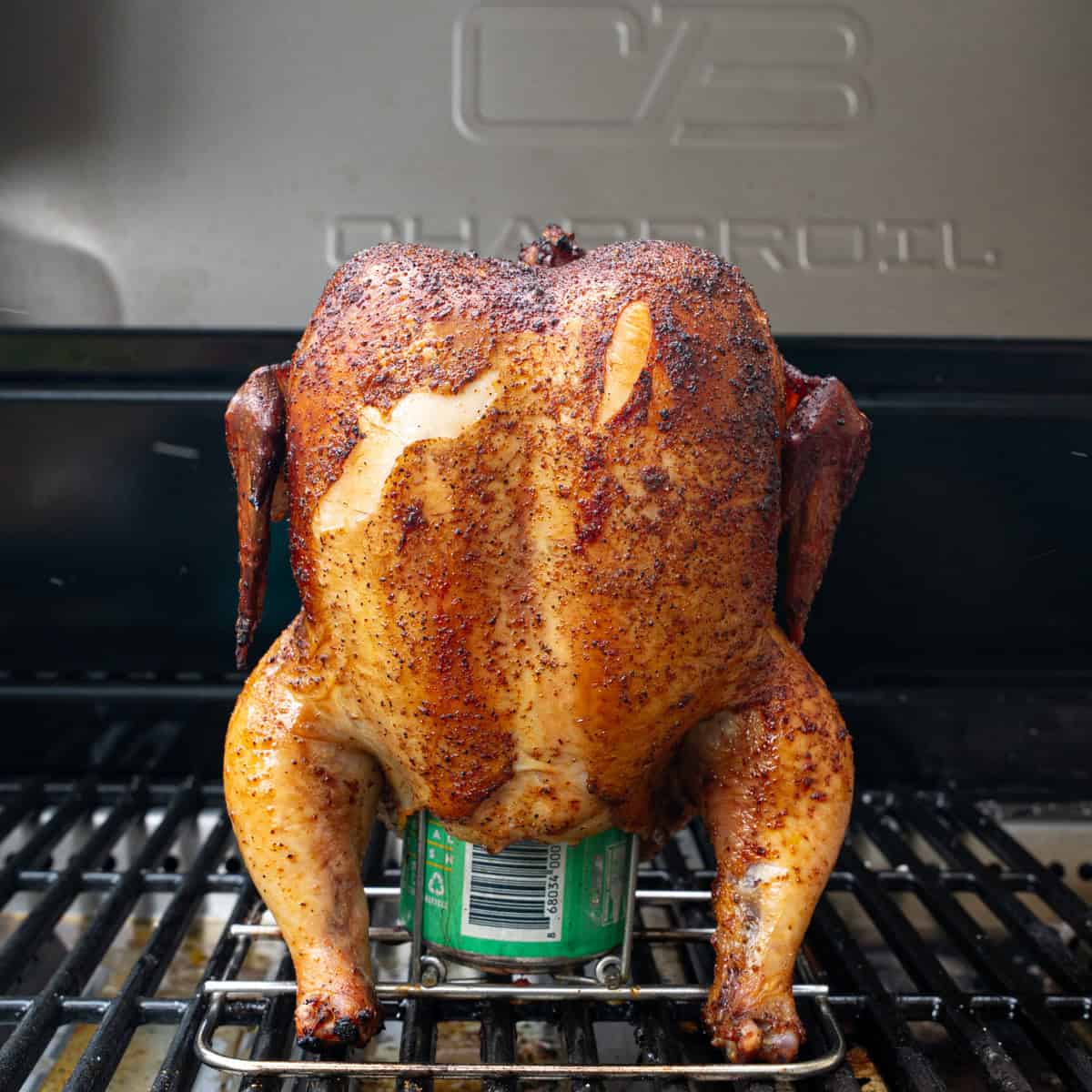 Smoked Beer can chicken on the grill before being glazed with BBQ sauce