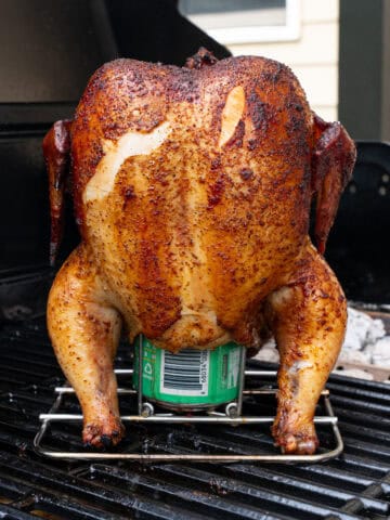 Smoked Beer can chicken on the grill before being glazed with BBQ sauce