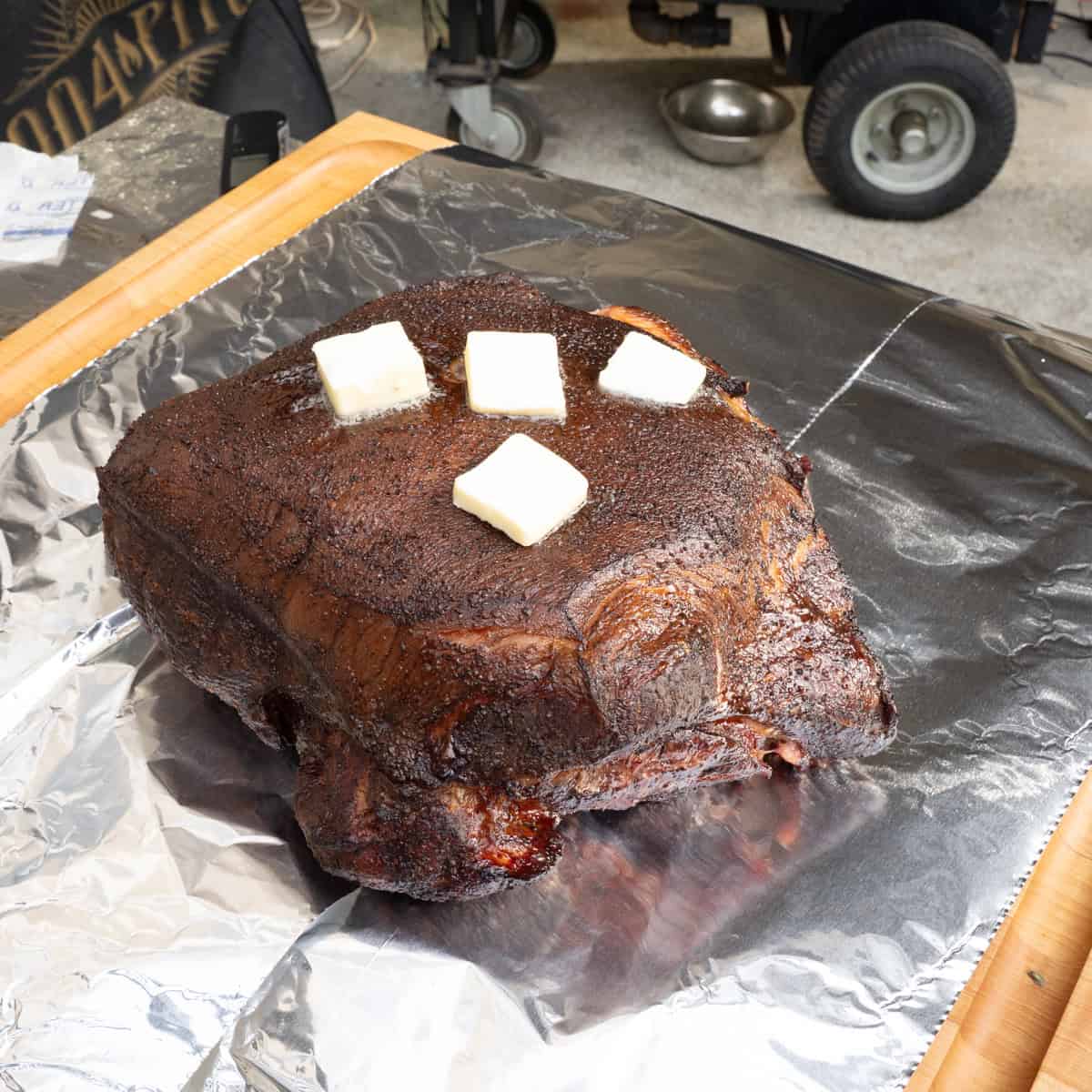 Pork butt recently passed through the stall and taken off of the smoker to be wrapped with butter