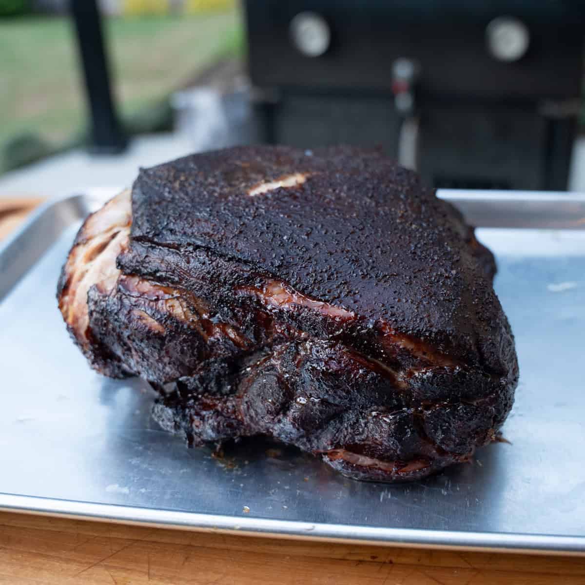 A smoked pork butt fresh off of the smokeand taken out of the wrap