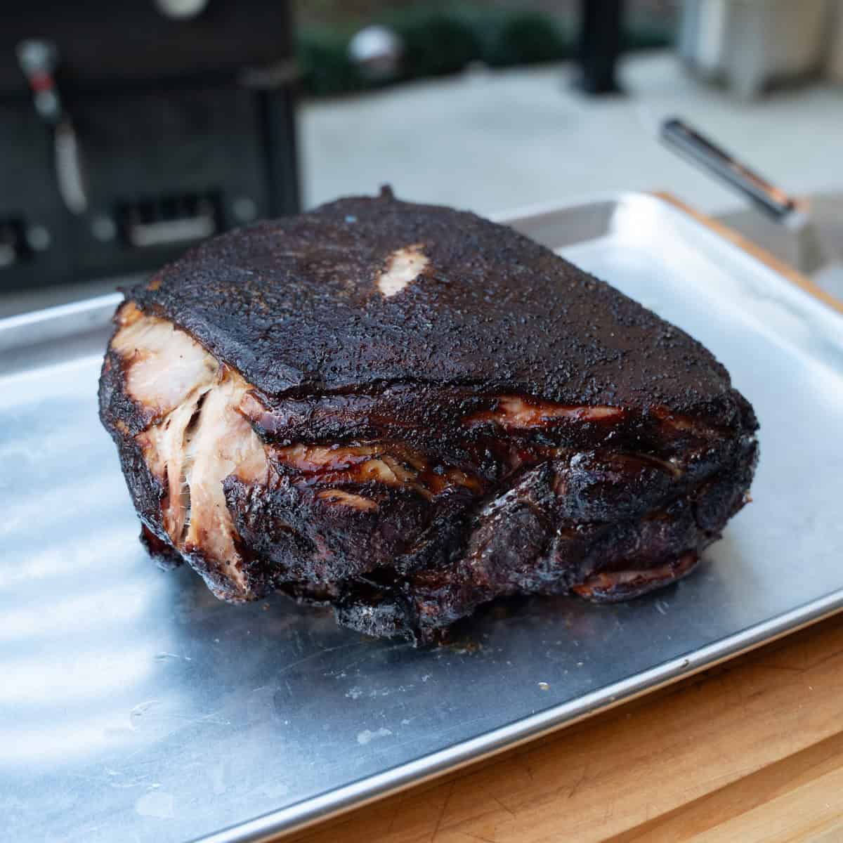 A smoked pork butt fresh off of the smokeand taken out of the wrap