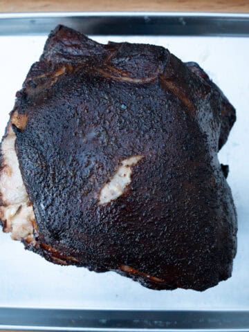 A smoked pork butt fresh off of the smokeand taken out of the wrap